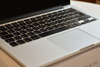 Detailed view of a MacBook Pro keyboard and trackpad, emphasizing modern design.