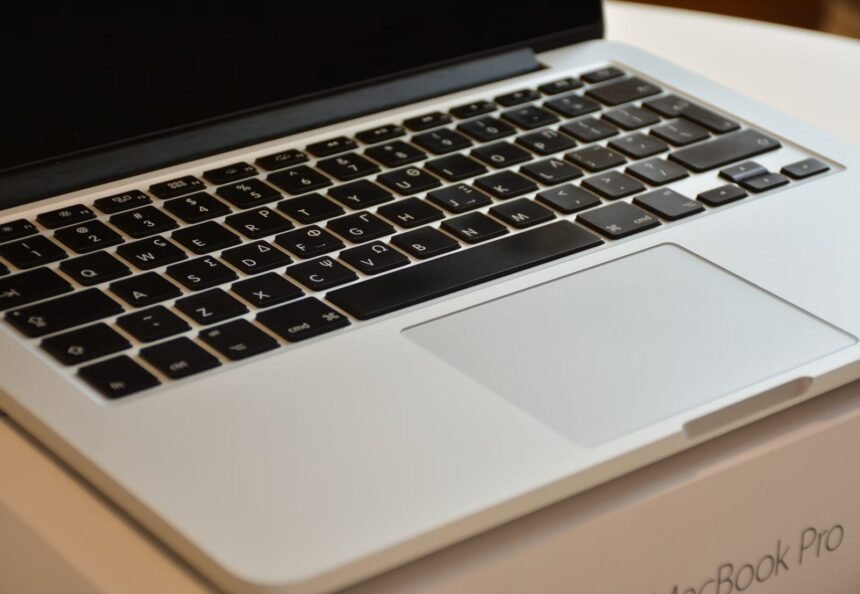 Detailed view of a MacBook Pro keyboard and trackpad, emphasizing modern design.