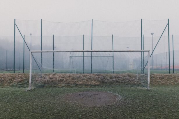 Misty football field featuring a frosty goal post and fog enveloping the sports ground.