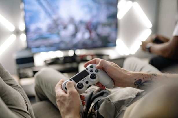 Hands holding a video game controller in a modern living room, playing on TV.