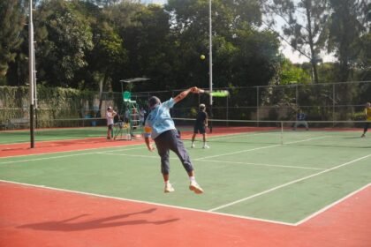 Dynamic tennis match on an outdoor court with players in motion, showcasing athleticism and teamwork.