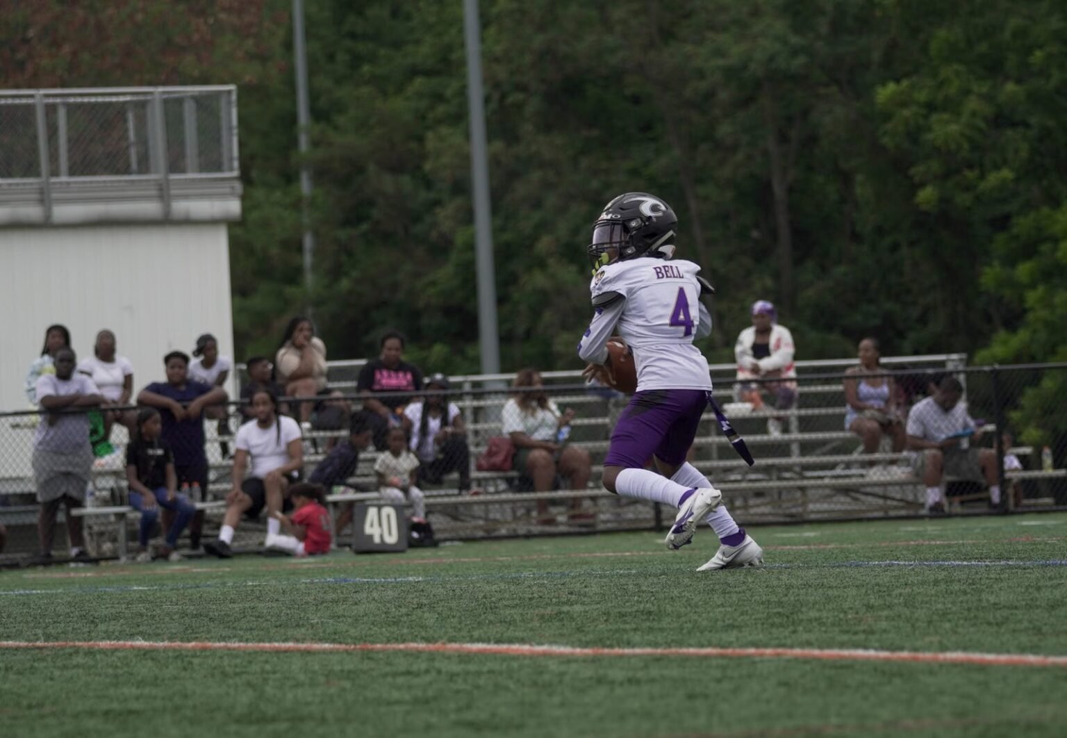 A young athlete runs on a football field during a game in Columbia, MD.