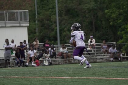 A young athlete runs on a football field during a game in Columbia, MD.