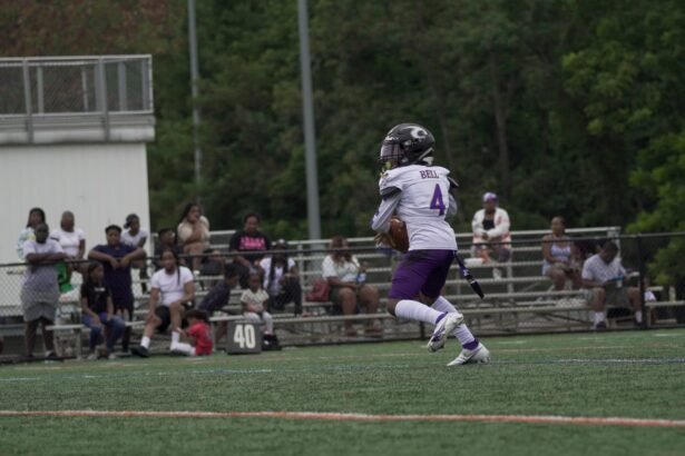 A young athlete runs on a football field during a game in Columbia, MD.