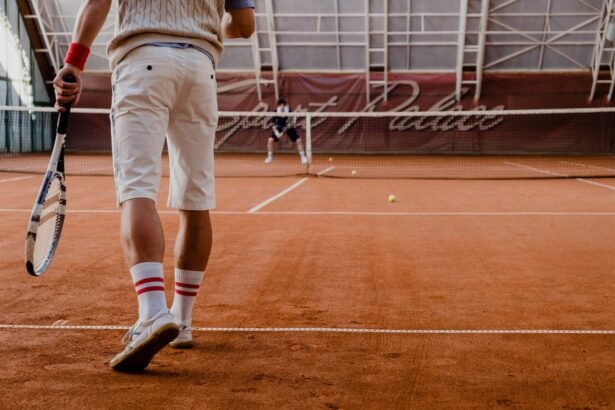 Players competing in a tennis match on an indoor clay court.