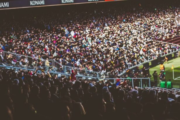 A crowded soccer stadium packed with enthusiastic fans during a match.