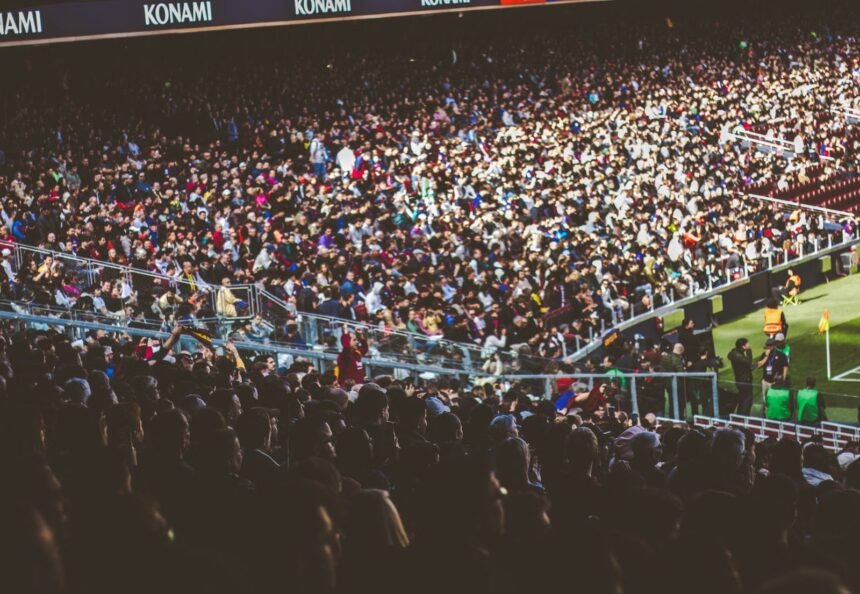 A crowded soccer stadium packed with enthusiastic fans during a match.