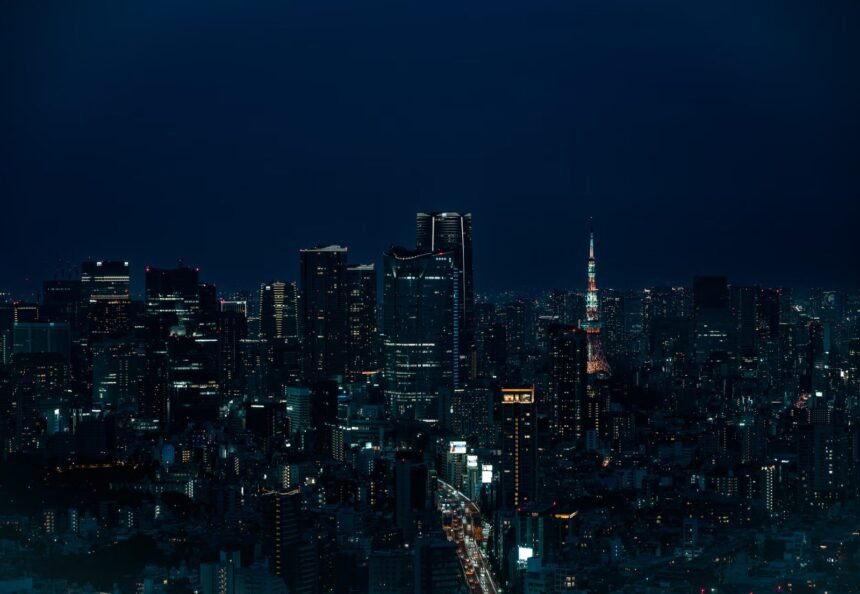 Stunning nighttime view of Tokyo skyline with illuminated Tokyo Tower in Shibuya, Japan.