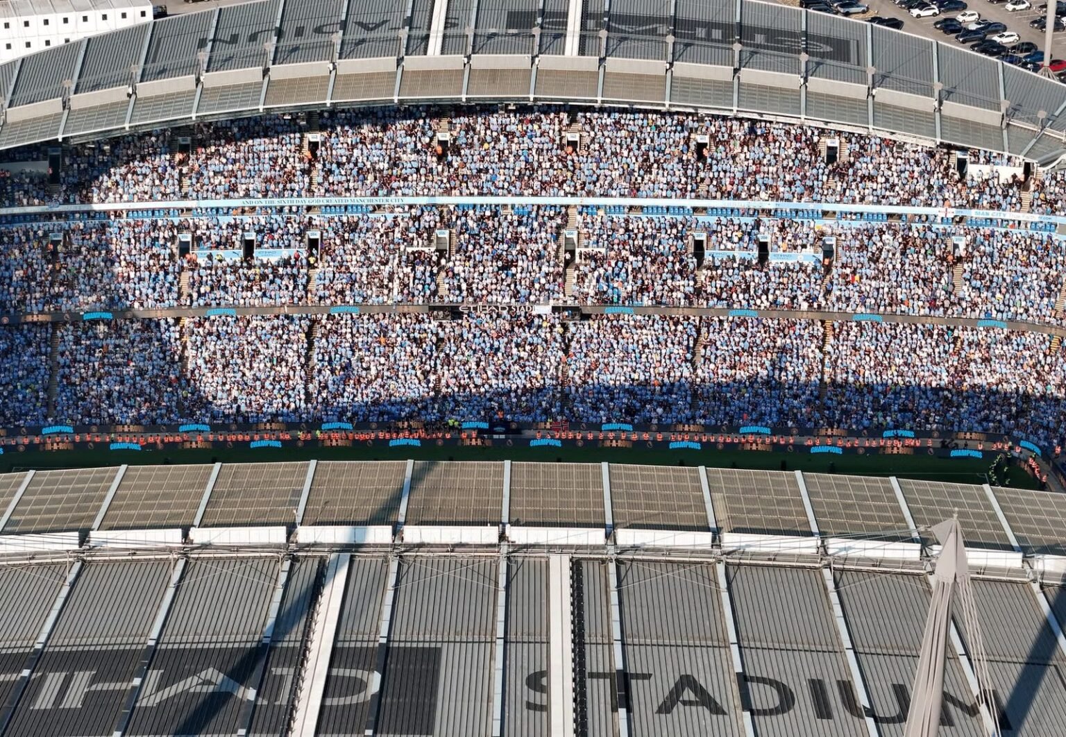 Aerial shot of Etihad Stadium filled with soccer fans in Manchester, UK.