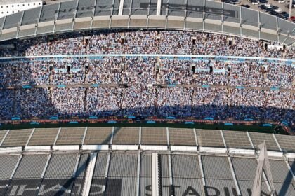 Aerial shot of Etihad Stadium filled with soccer fans in Manchester, UK.
