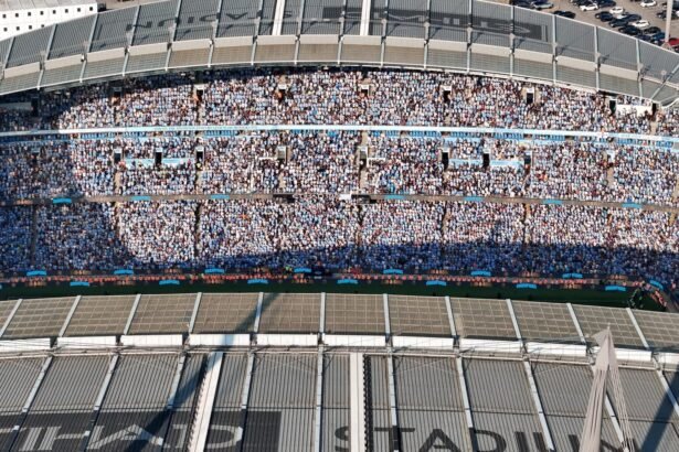 Aerial shot of Etihad Stadium filled with soccer fans in Manchester, UK.
