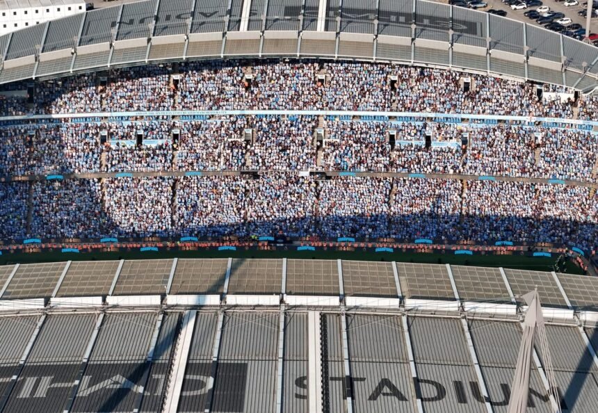 Aerial shot of Etihad Stadium filled with soccer fans in Manchester, UK.