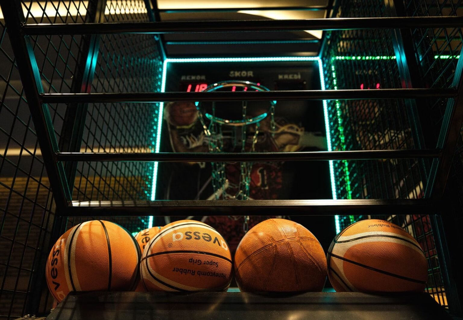 Close-up view of basketballs lined up for an arcade basketball hoop game.