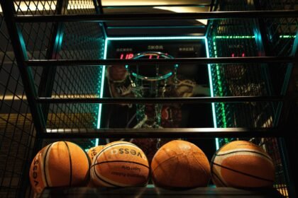 Close-up view of basketballs lined up for an arcade basketball hoop game.