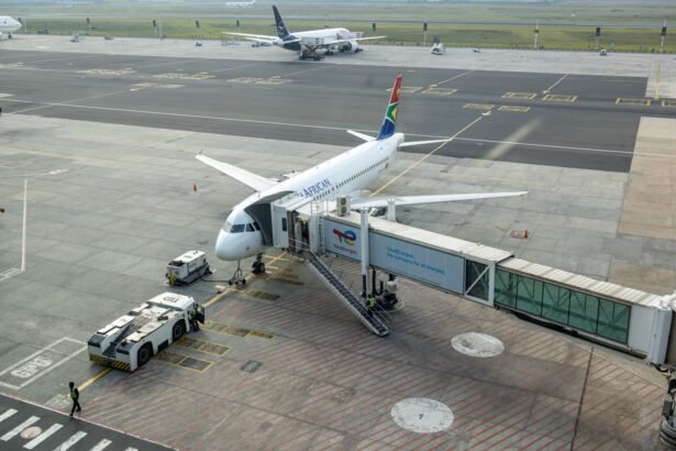 South African Airways plane docked at a gate in an airport, captured from an aerial view.