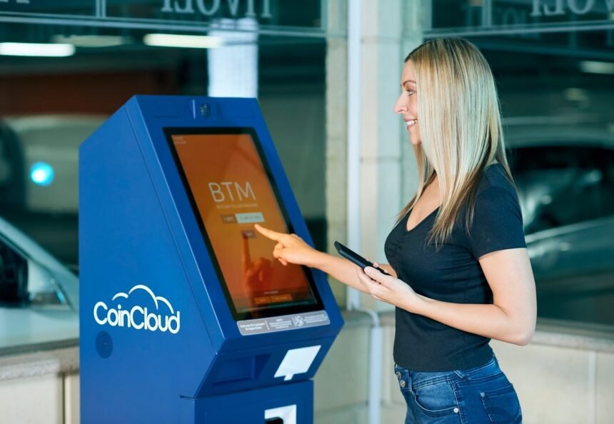 A woman interacts with a CoinCloud machine indoors, showcasing modern digital banking.