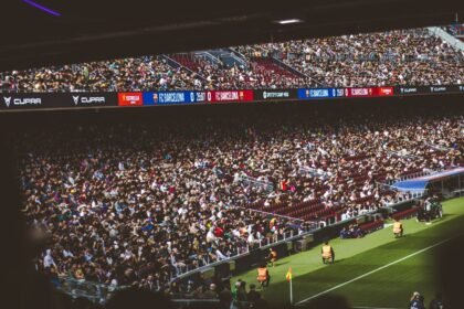 Packed stadium with spectators at an FC Barcelona soccer match, vibrant atmosphere.