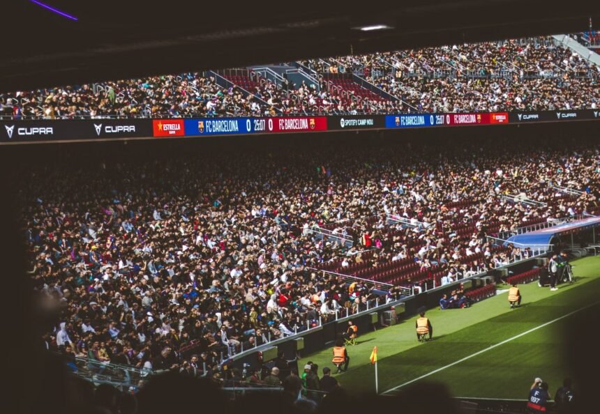 Packed stadium with spectators at an FC Barcelona soccer match, vibrant atmosphere.