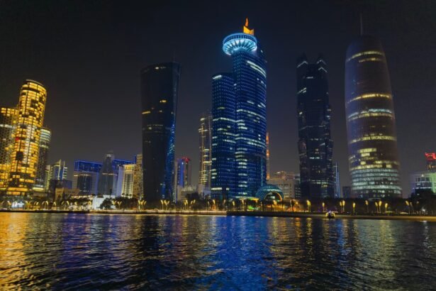 Captivating night scene of Doha's illuminated skyline reflecting on water in Qatar.