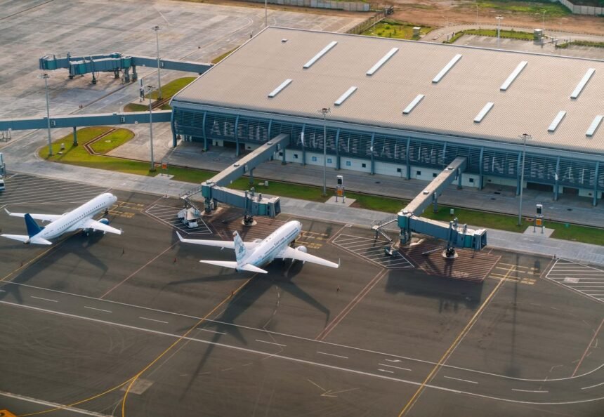 Aerial view of Abeid Amani Karume International Airport in Zanzibar, showing parked airplanes and terminal.