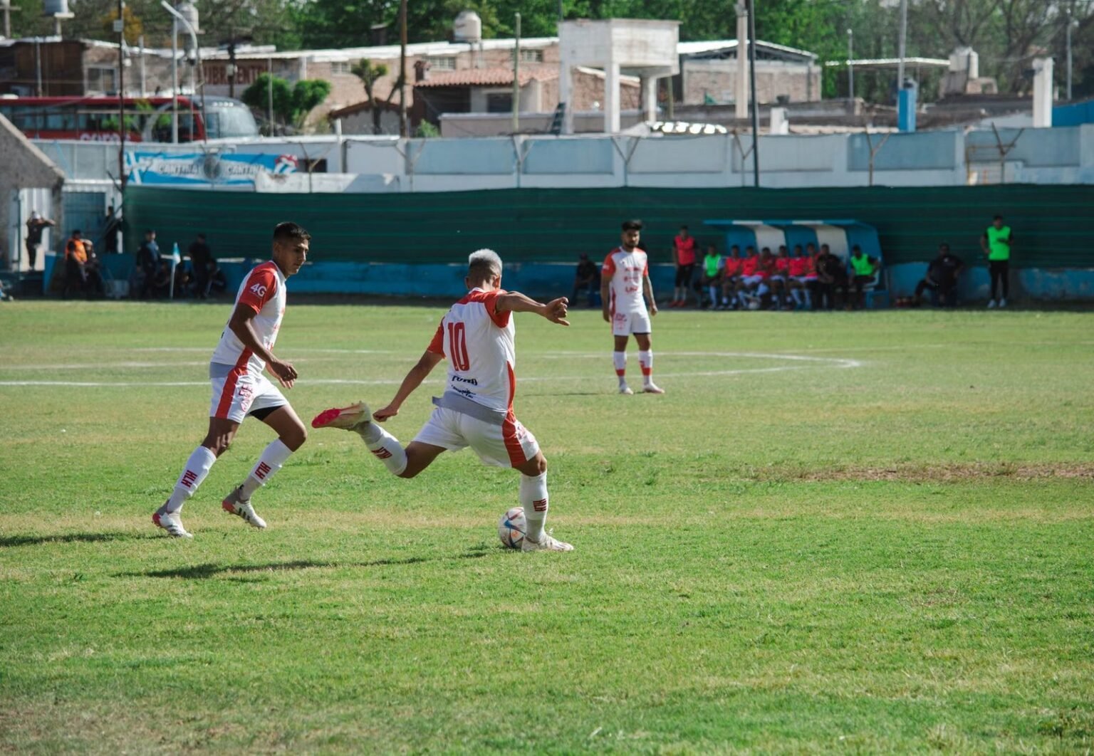 Intense soccer game in Mina, Mendoza, Argentina showcasing teamwork and action on a sunny day.