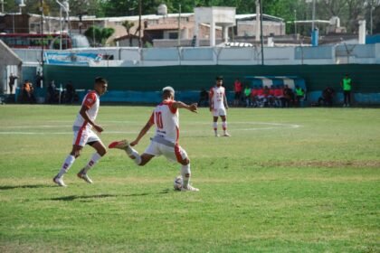 Intense soccer game in Mina, Mendoza, Argentina showcasing teamwork and action on a sunny day.