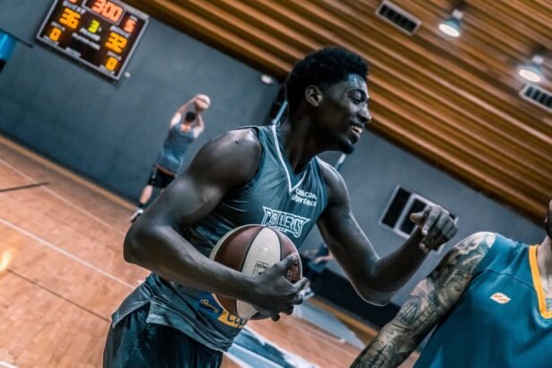 Engaging moment of basketball players during an indoor training session on a wooden court.