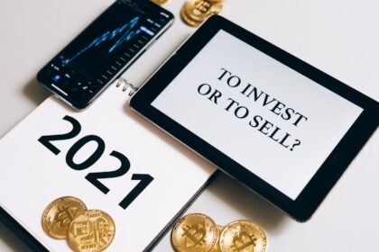 Bitcoin and investment strategy visualized with smartphone, tablet, and coins.