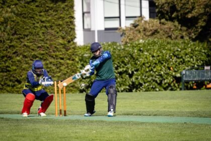 A thrilling moment captured during a cricket game with the batter and wicket-keeper in action.